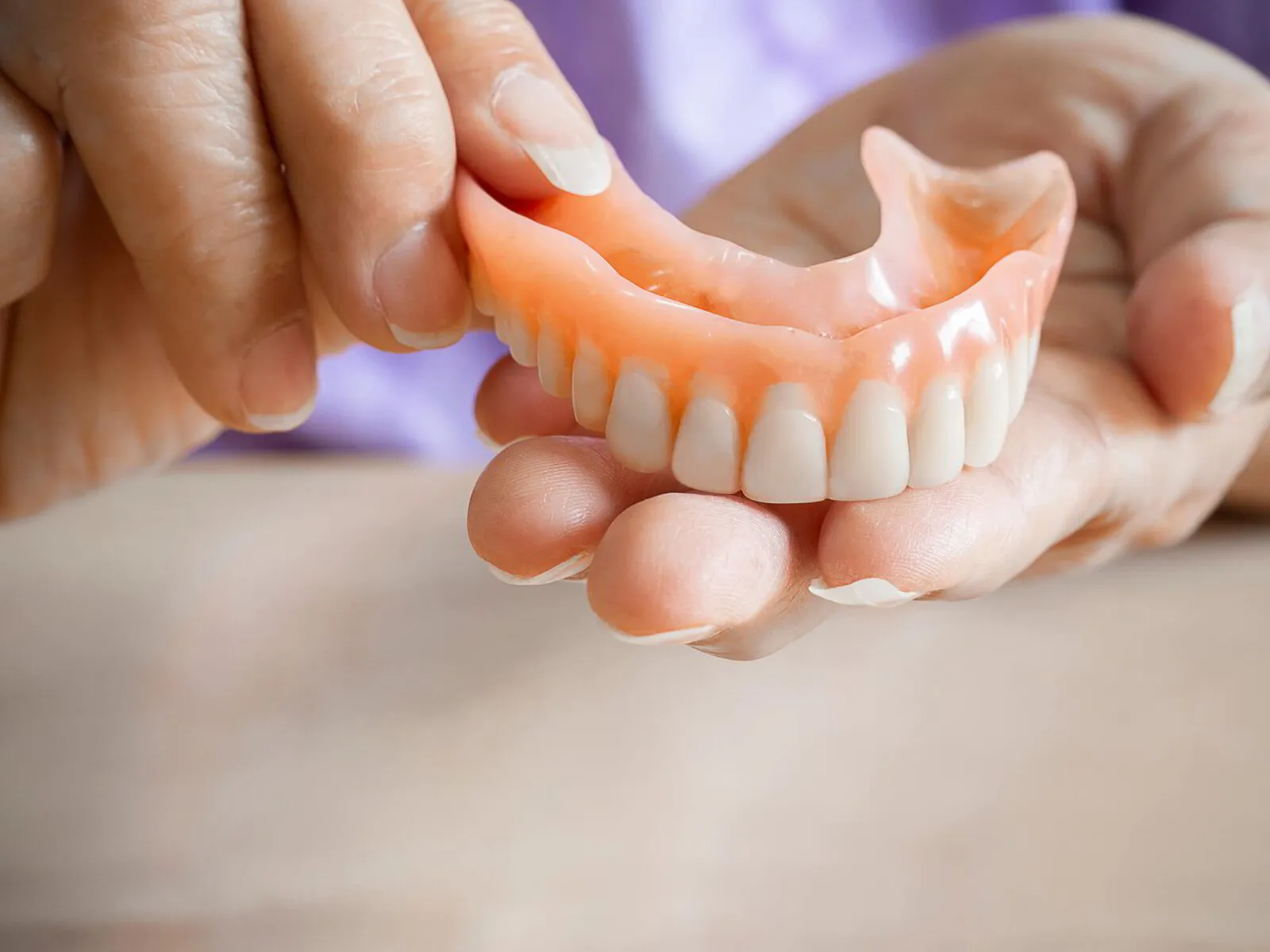 Patient with a confident, natural-looking denture smile